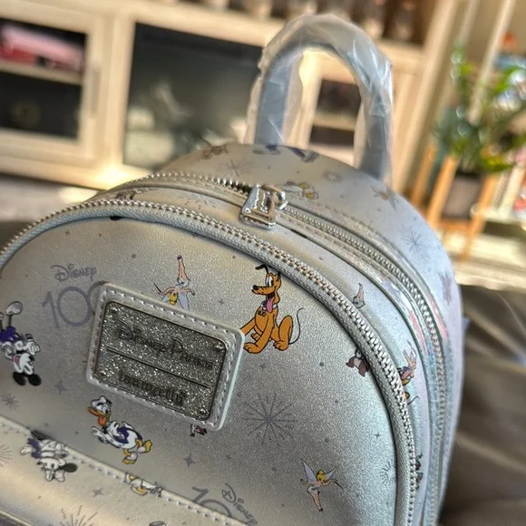 Collectible Disney 100 Loungefly Silver Character Backpack - Picture 2 of 5